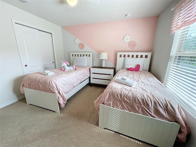 carpeted bedroom with a closet and ceiling fan