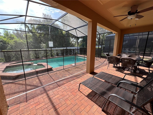 view of pool with an in ground hot tub, a patio, ceiling fan, and a lanai