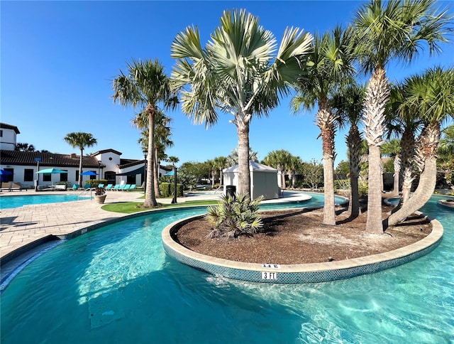 view of swimming pool featuring a patio area and a hot tub