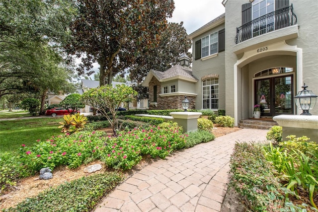 exterior space with a balcony and french doors