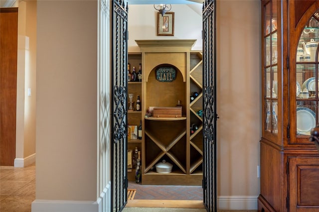 wine room featuring light tile patterned flooring and baseboards