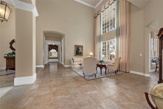 interior space featuring a towering ceiling and ornamental molding