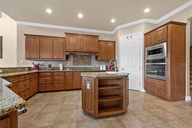 kitchen featuring open shelves, a center island with sink, brown cabinets, and stainless steel appliances