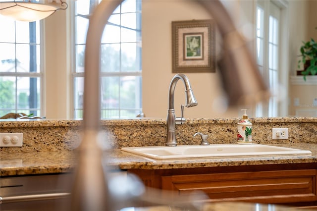 details featuring sink and light stone countertops