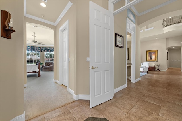 hallway with light carpet and crown molding