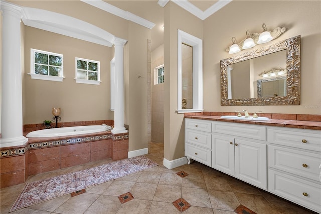 bathroom featuring tile patterned flooring, decorative columns, tiled tub, vanity, and ornamental molding