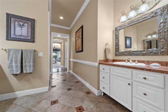 bathroom featuring tile patterned flooring, baseboards, crown molding, and vanity