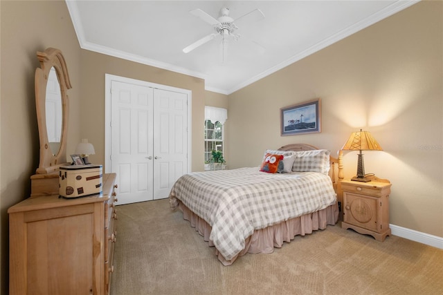 bedroom featuring ornamental molding, light colored carpet, a closet, and ceiling fan