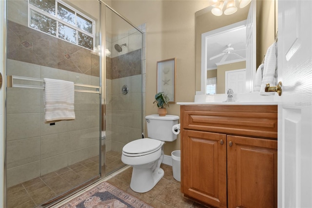 bathroom with vanity, ceiling fan, a shower with shower door, crown molding, and toilet