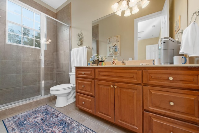 bathroom with toilet, tile patterned floors, a stall shower, and vanity