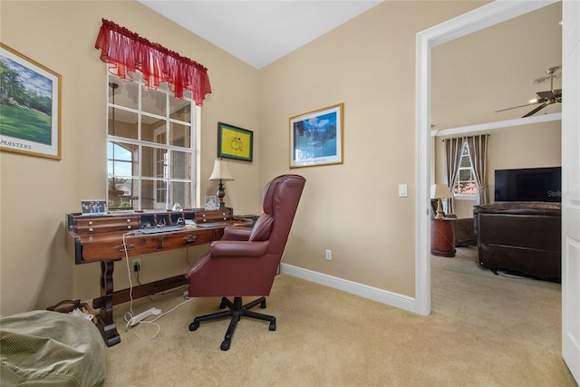 home office with a ceiling fan, light carpet, and baseboards