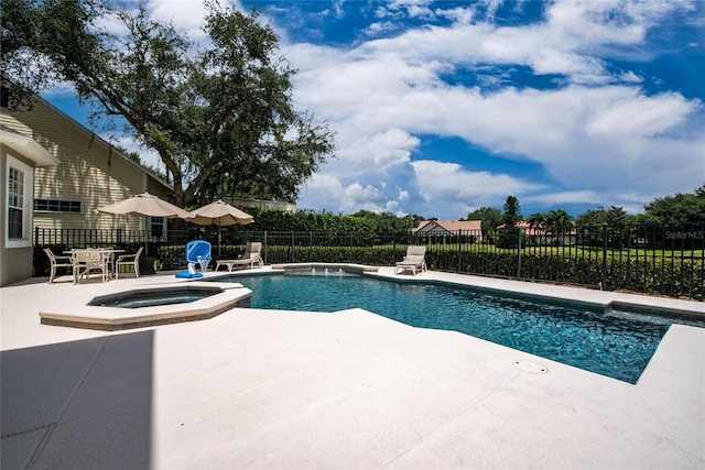 view of pool featuring a patio and an in ground hot tub