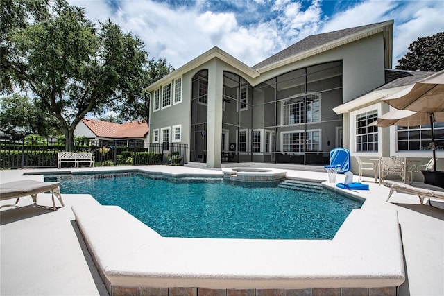 view of pool featuring a patio area, a pool with connected hot tub, and fence