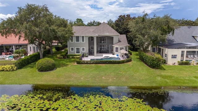 view of front of property with a front yard and a water view