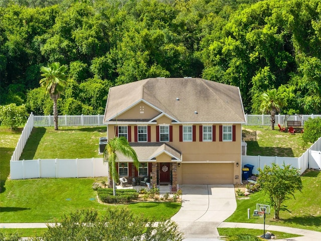 view of front of home with a front yard and a garage