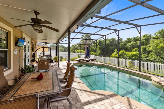 view of pool featuring a lanai, ceiling fan, and a patio