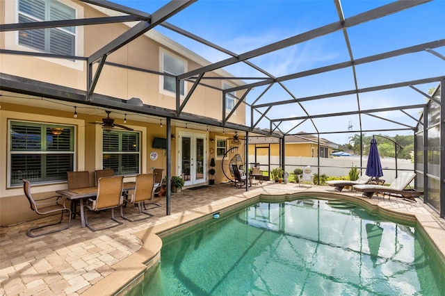 view of pool featuring a lanai, a fenced in pool, a patio, and french doors