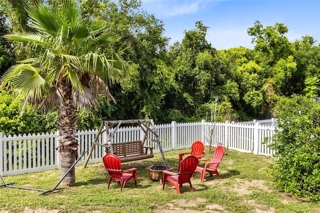 view of yard featuring an outdoor fire pit and a fenced backyard