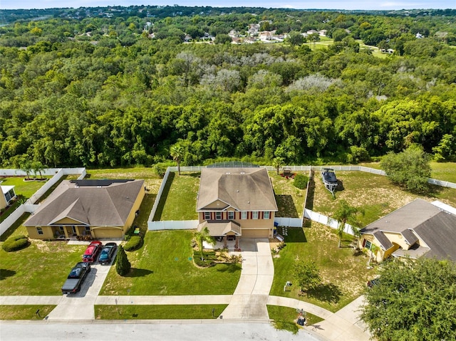 birds eye view of property with a forest view