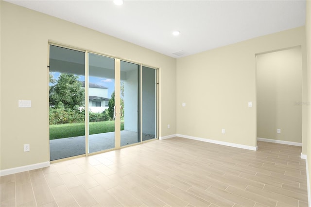 spare room featuring light hardwood / wood-style flooring