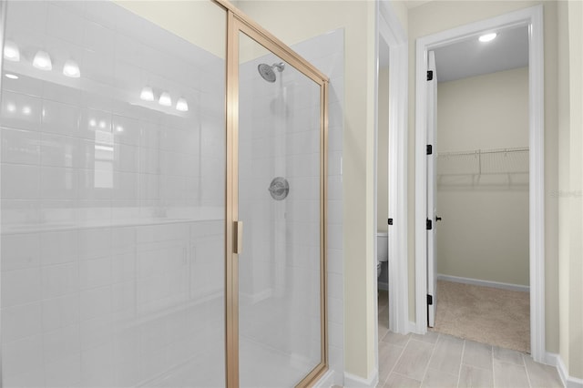 bathroom with walk in shower and toilet