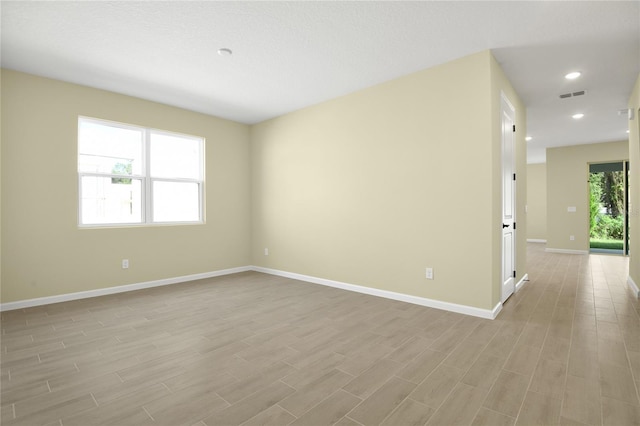 unfurnished room with light wood-type flooring