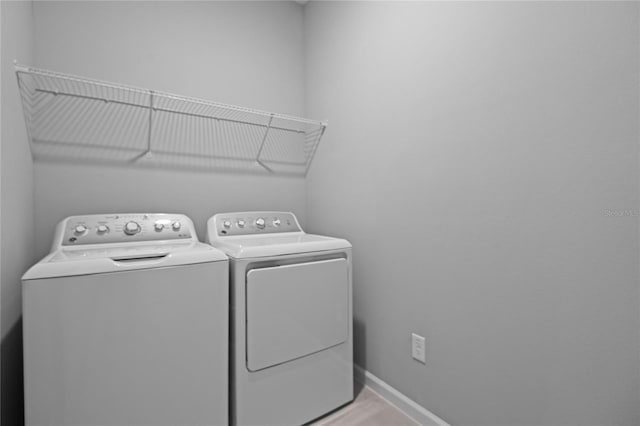 washroom featuring washer and clothes dryer