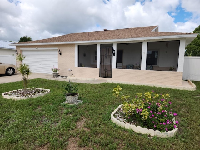 2518 Bowmer Dr, Kissimmee, FL 34744 - back of property with brick siding, a sunroom, a garage, and a shingled roof