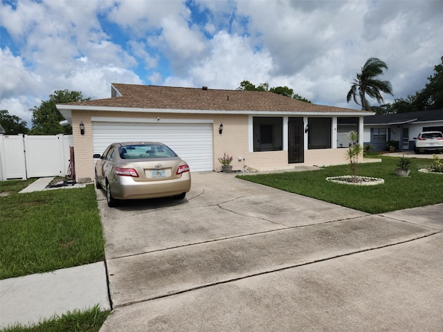 single story home with a garage and a front yard