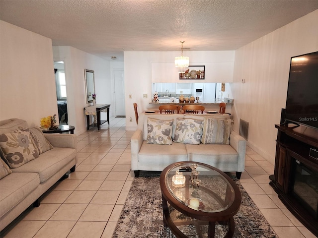 2518 Bowmer Dr, Kissimmee, FL 34744 - living area featuring a textured ceiling, light tile patterned flooring, and a chandelier