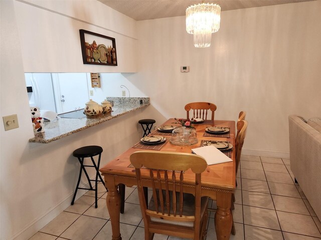 2518 Bowmer Dr, Kissimmee, FL 34744 - dining space with light tile patterned floors, a chandelier, and baseboards