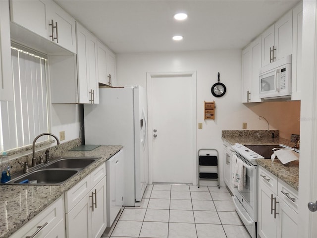 kitchen featuring white cabinetry, sink, white appliances, and light tile patterned floors