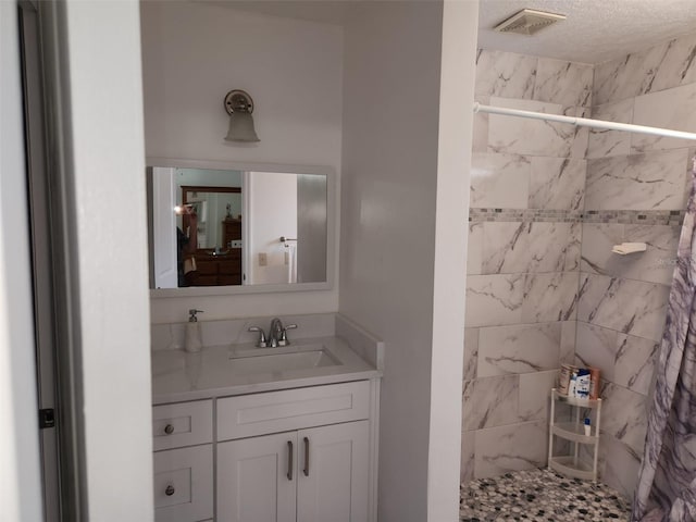 bathroom featuring vanity and a textured ceiling