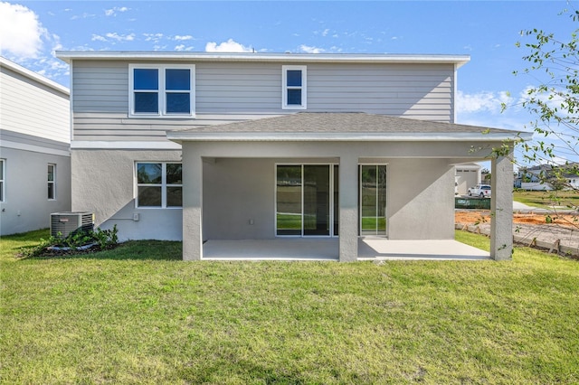 back of house featuring a lawn, cooling unit, and a patio area