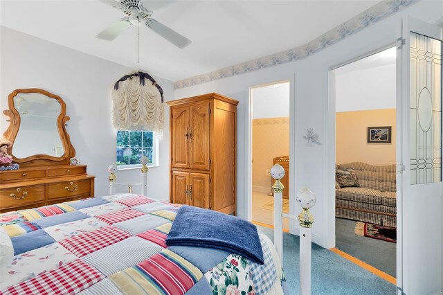 bedroom featuring carpet, ensuite bathroom, and ceiling fan