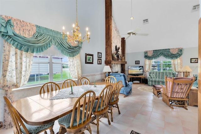 dining area featuring light tile patterned flooring, ceiling fan with notable chandelier, high vaulted ceiling, and plenty of natural light