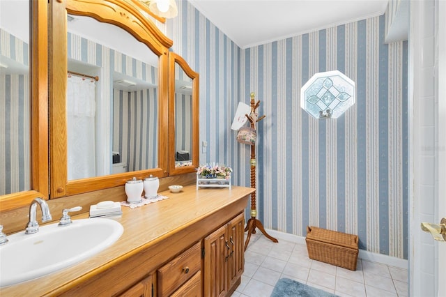 bathroom featuring tile patterned flooring, crown molding, and vanity