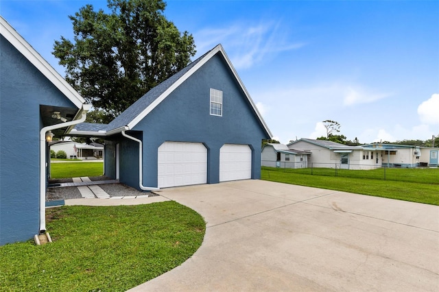 view of home's exterior featuring a garage and a lawn