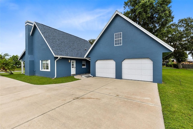 view of front of house with a garage and a front lawn