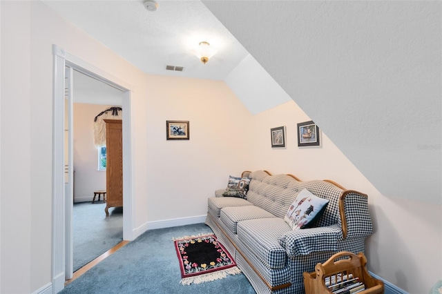 carpeted living room with lofted ceiling