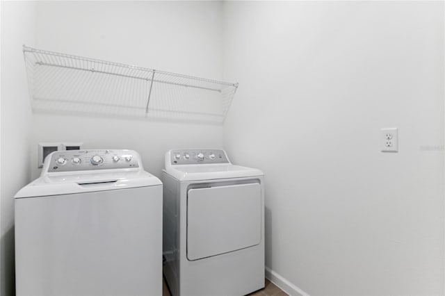 clothes washing area with separate washer and dryer