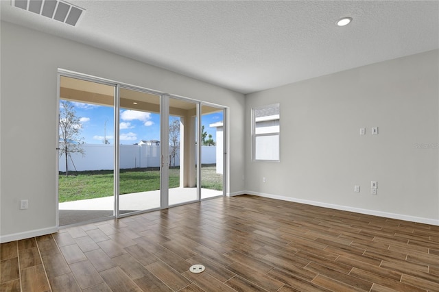 unfurnished room featuring a textured ceiling