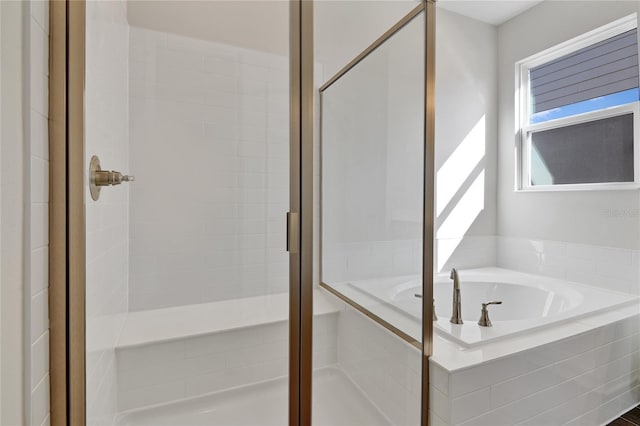 bathroom with shower with separate bathtub