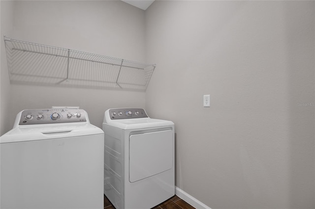 washroom with dark wood-type flooring and separate washer and dryer