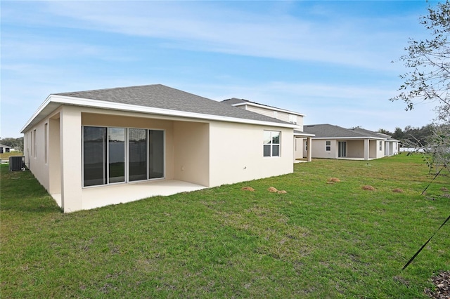 back of property with a patio, a yard, and cooling unit