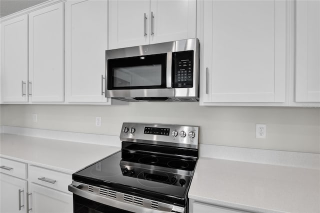 kitchen featuring white cabinets and appliances with stainless steel finishes