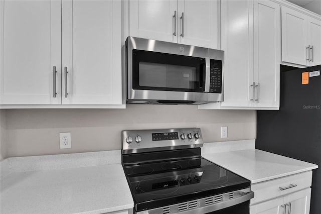 kitchen with white cabinetry and appliances with stainless steel finishes