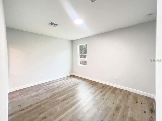 spare room featuring light hardwood / wood-style flooring