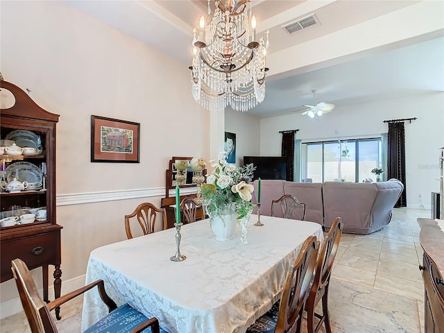 dining space with ceiling fan with notable chandelier and light tile patterned floors