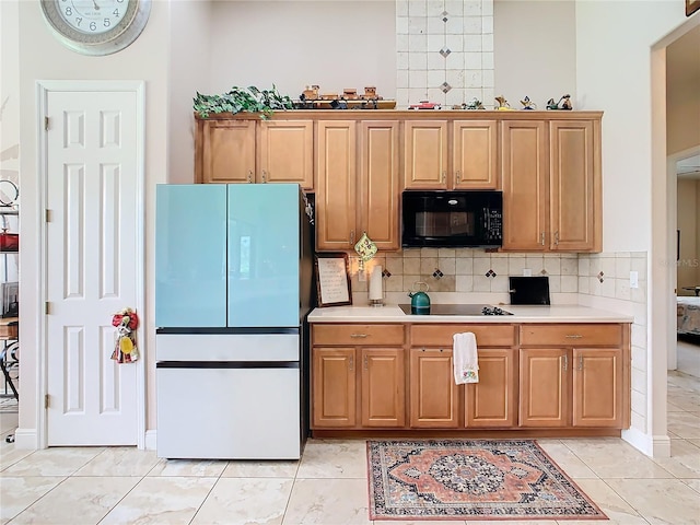 kitchen featuring light tile patterned flooring, tasteful backsplash, and black appliances